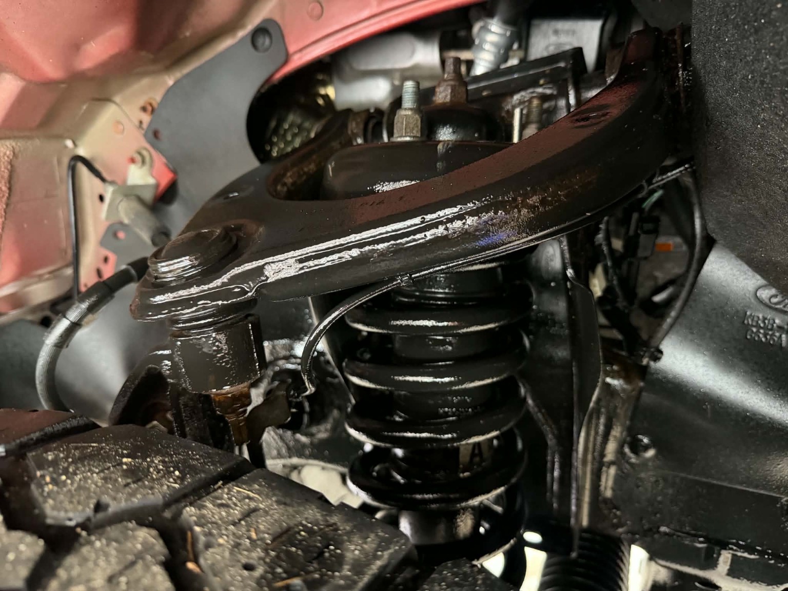 Suspension and underbody components photographed during a Midnight Detailing undercoating service